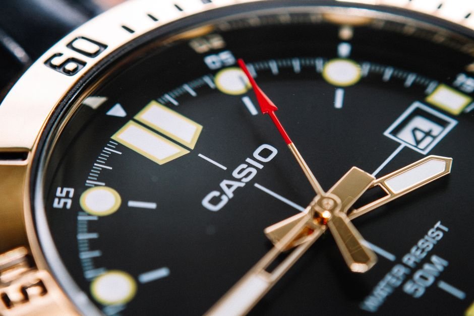 Close-up of a Casio analog wrist watch with alarm function and a black dial.