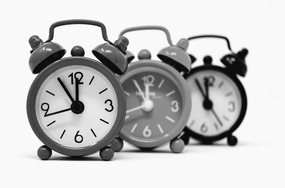 Three vintage-style alarm clocks in black and white, illustrating options for heavy sleepers.