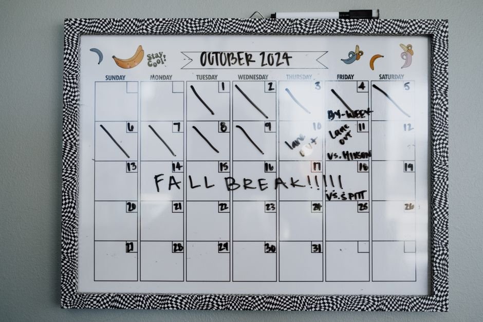 A family wall calendar for October 2024, featuring notes and a decorative frame, relevant to family calendar reviews.