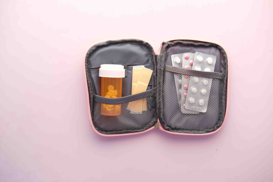 A waterproof pill case containing a prescription bottle and blister packs, relevant to keeping meds dry.