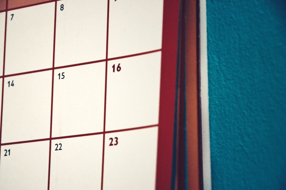 A close-up view of a wall calendar showing the 16th and 23rd dates, illustrating how to mount a calendar.