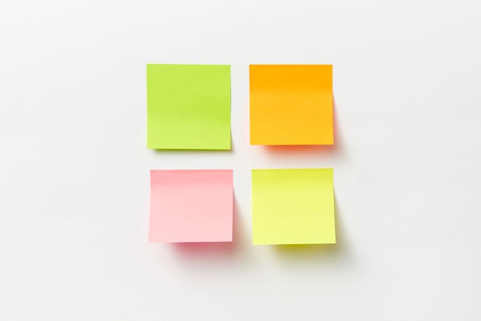 Sticky notes in green, orange, pink, and yellow for an ADHD reminder system.